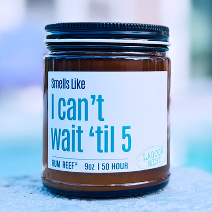 Jar of candle with funny i cant wait til 5 label on a blurred background